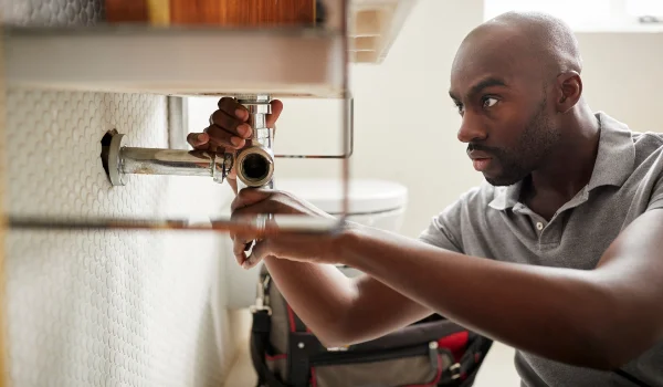 a male plumber fixing a pipe connection from Emergency Plumber San Marcos in San Marcos, TX 