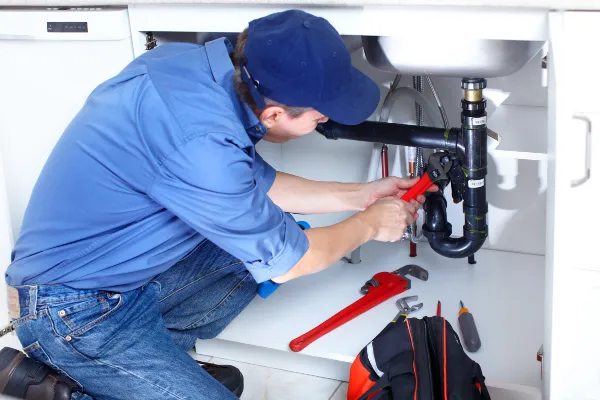 a male plumber fixing a toilet from Emergency Plumber San Marcos in San Marcos, TX 